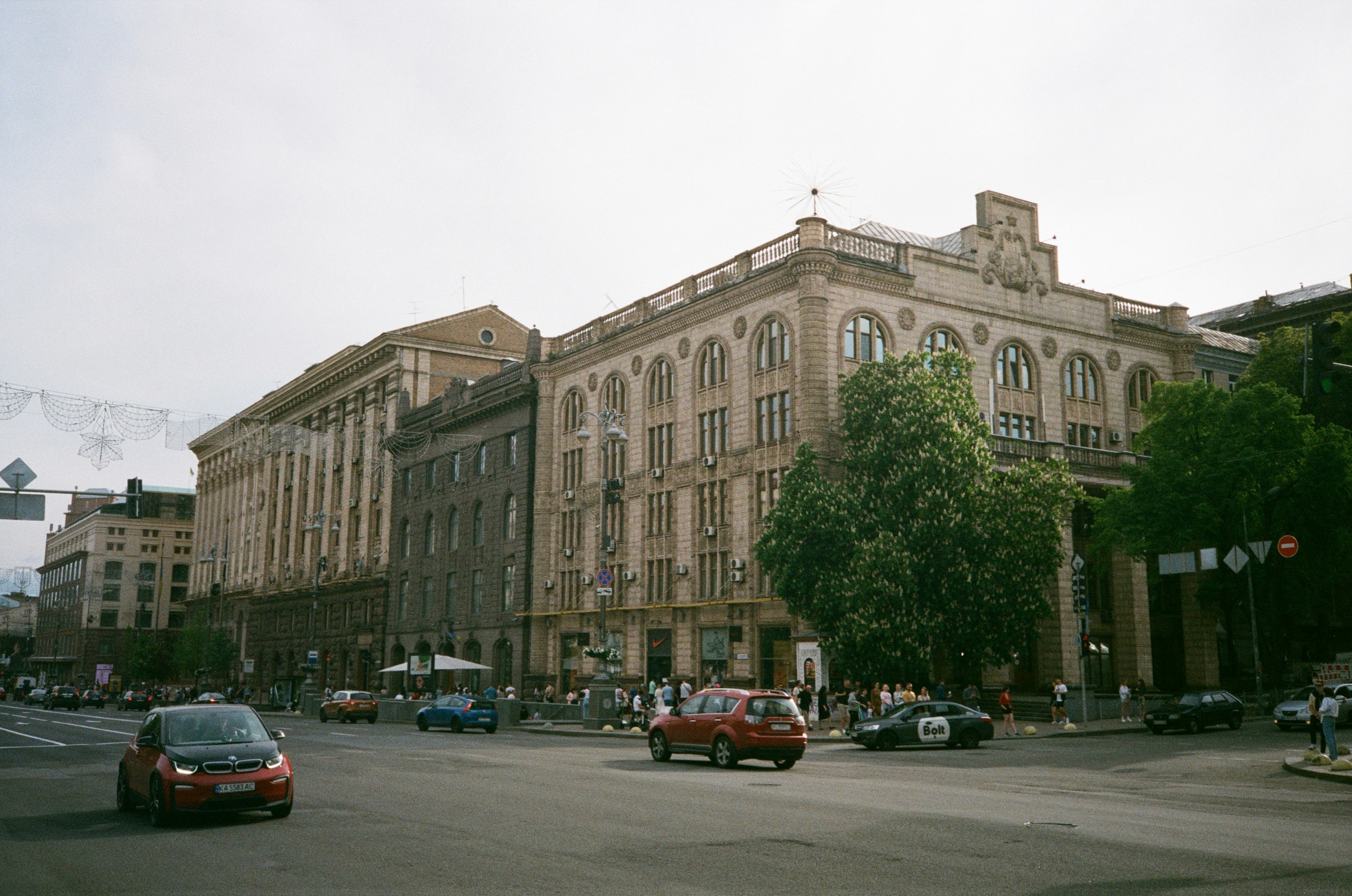 cars parked in front of brown concrete building during daytime