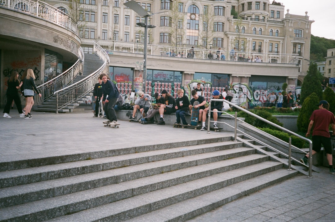 people walking on gray concrete stairs near white concrete building during daytime