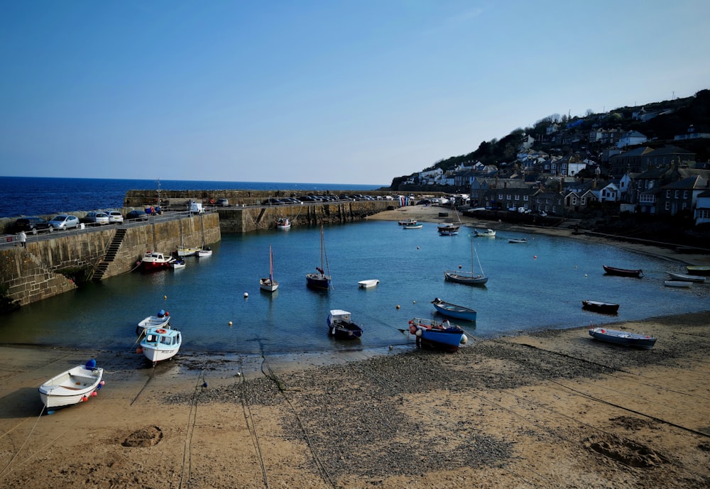 boats on sea near dock during daytime