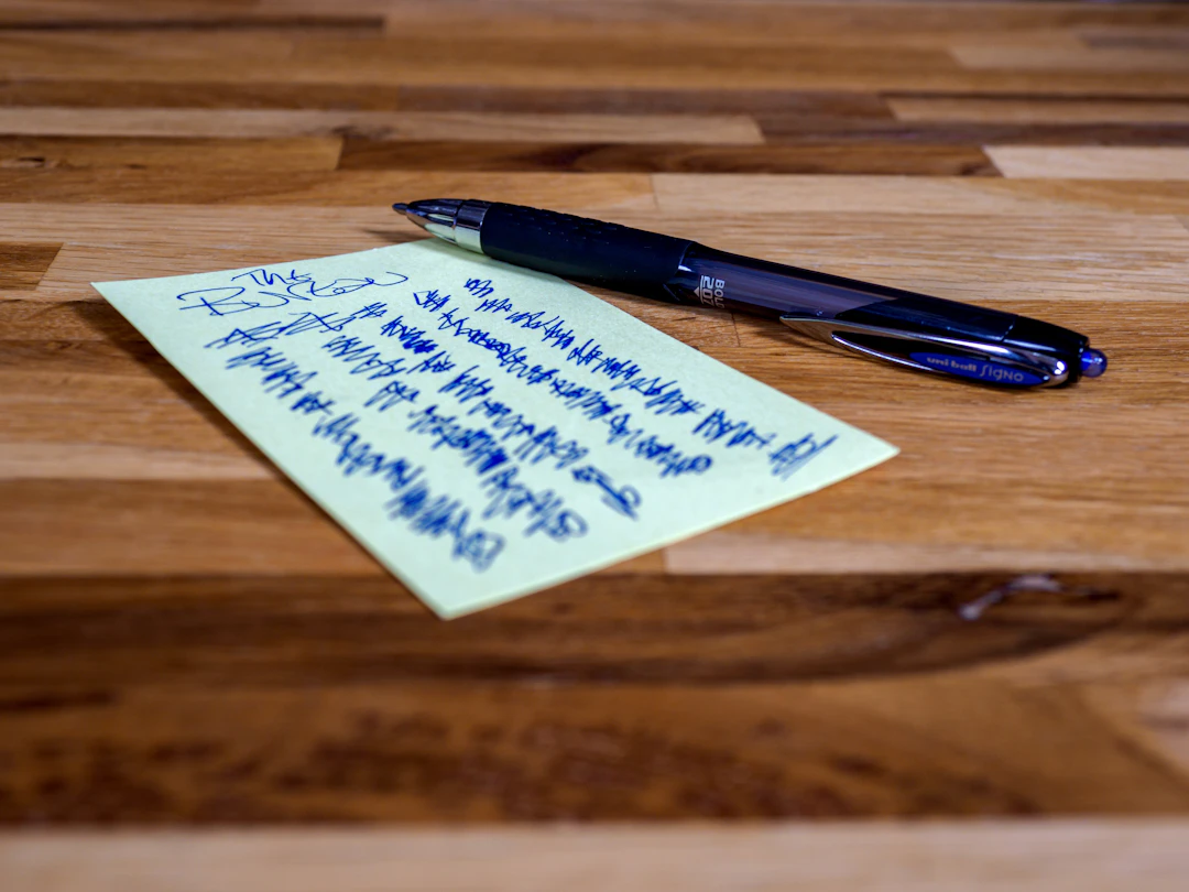 A blue pen resting on handwritten notes