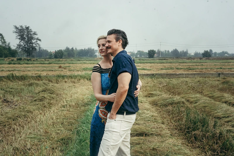 man in blue t-shirt standing on green field