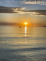 A tranquil sunset over a calm sea.