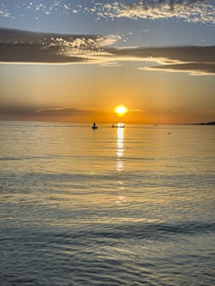 A tranquil sunset over a calm sea.