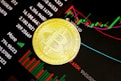 gold round coin on black surface