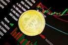 gold round coin on black surface