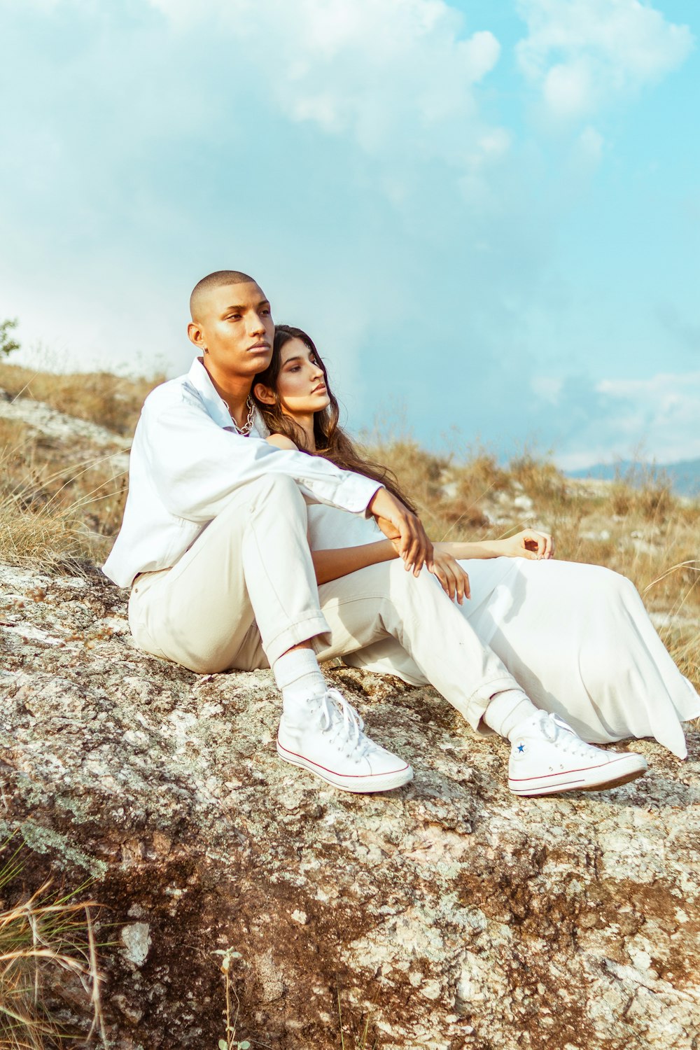 woman in white dress sitting on ground during daytime