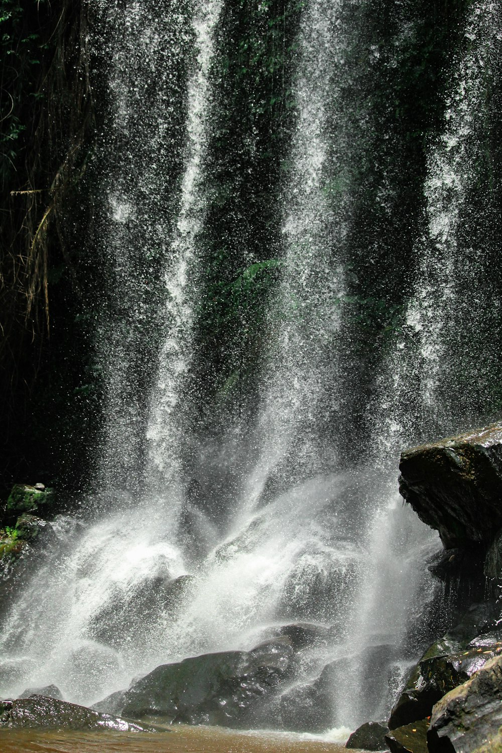 water falls on brown rock