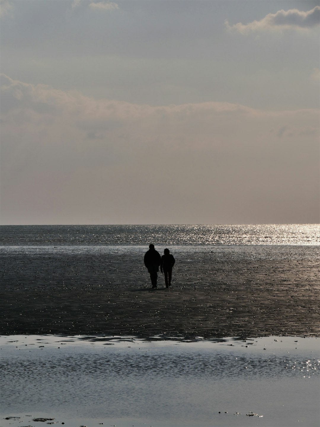 person walking on beach during sunset