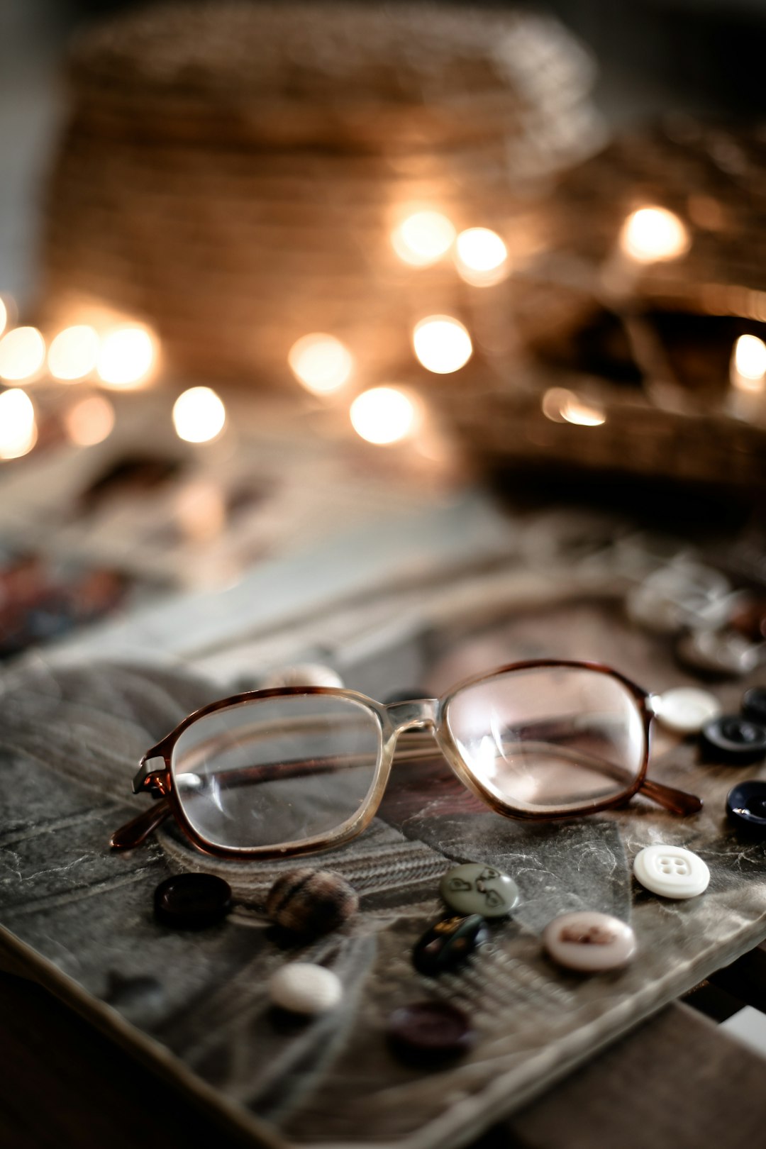 brown framed eyeglasses on black and white textile