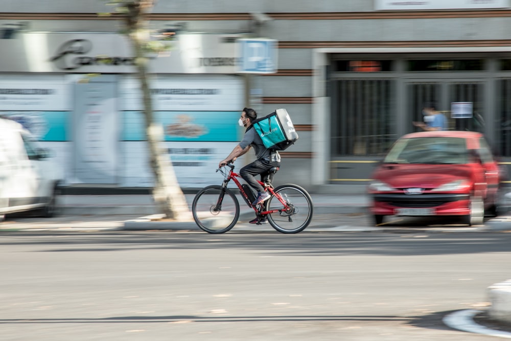 man in blue shirt riding bicycle on road during daytime