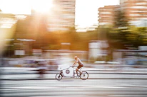 A delivery bike speeding through city streets on a sunny day