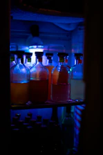 Close-up of industrial chemical containers with deep red bromine tones under soft lighting.