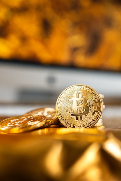 gold round coin on black surface