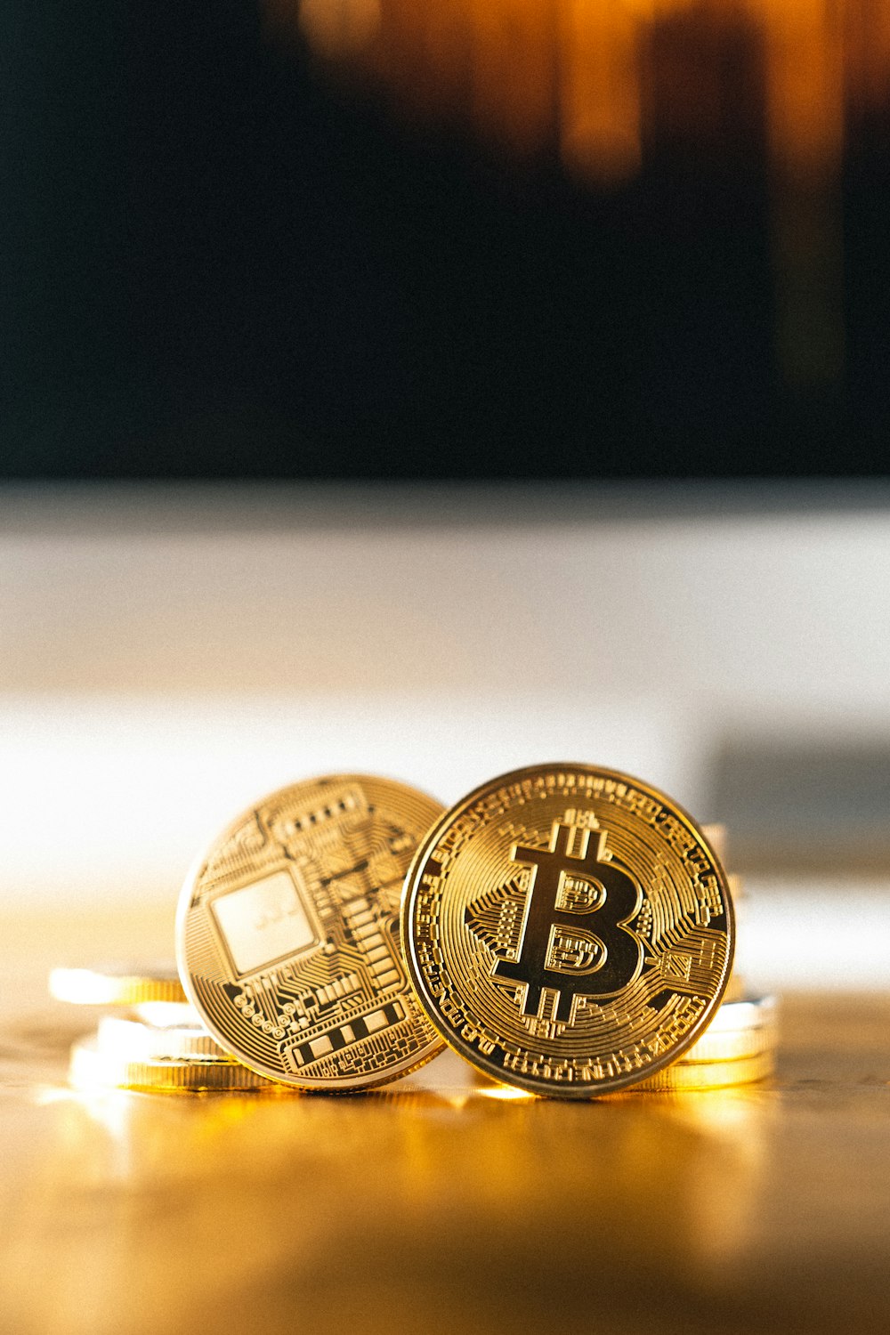 gold round coin on white surface