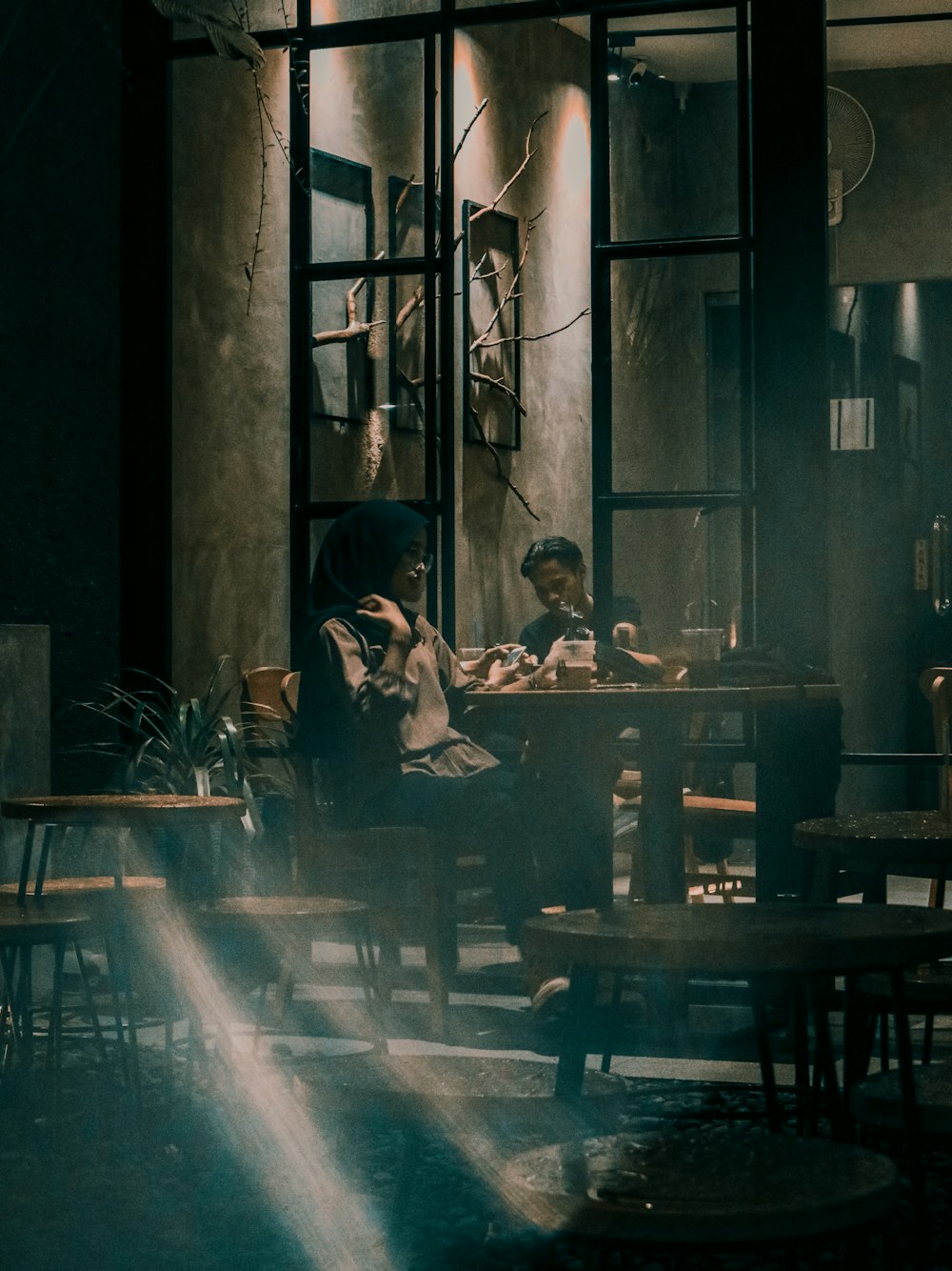 man in black jacket sitting on chair