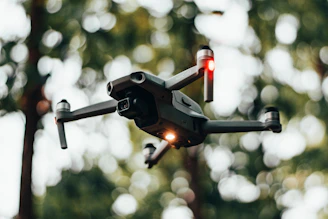 High-tech drone hovering mid-air with illuminated propellers in a dark setting