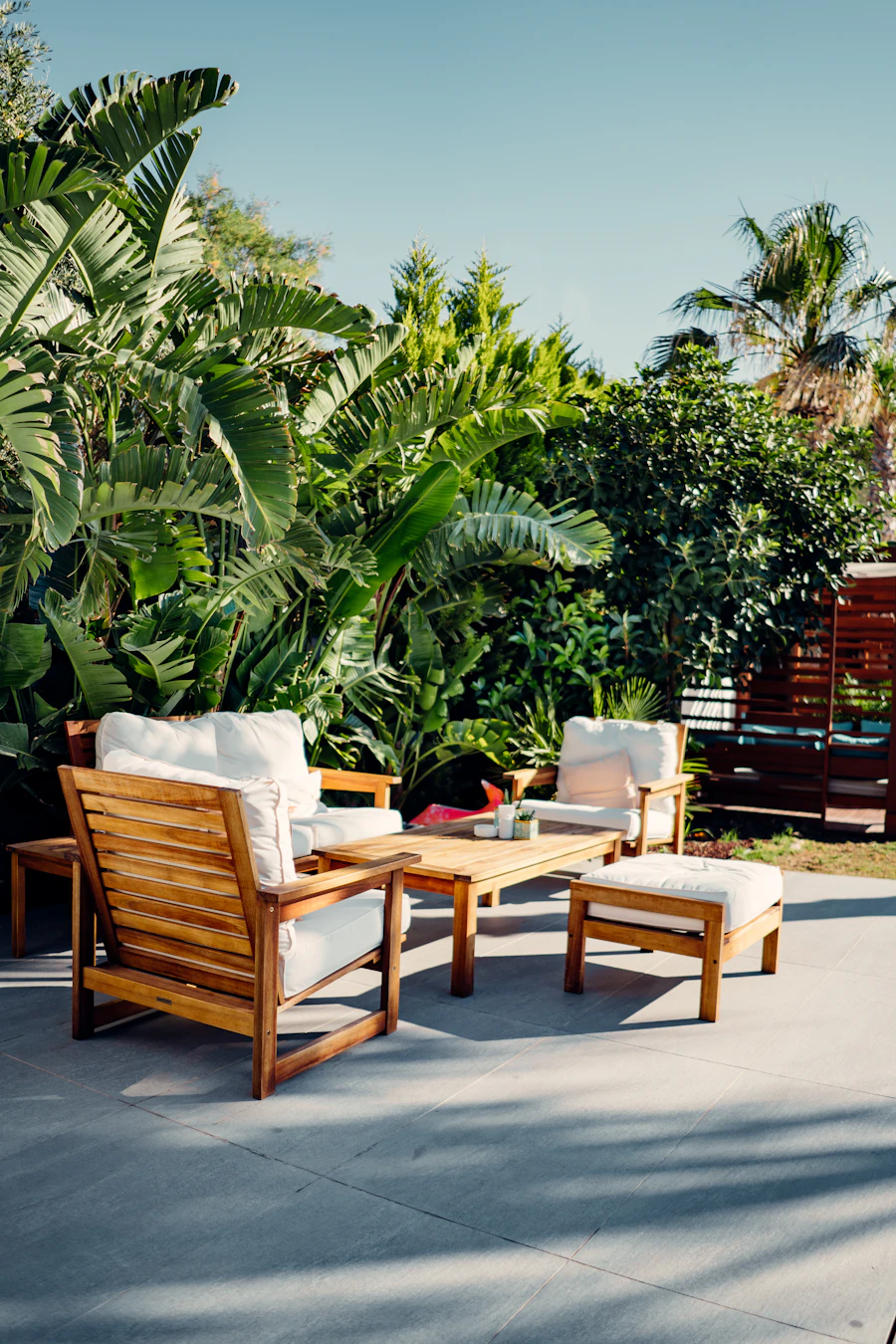 Brown wooden outdoor table and chairs on a patio