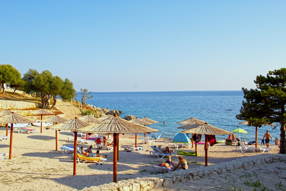 brown wooden beach lounge chairs on beach shore during daytime