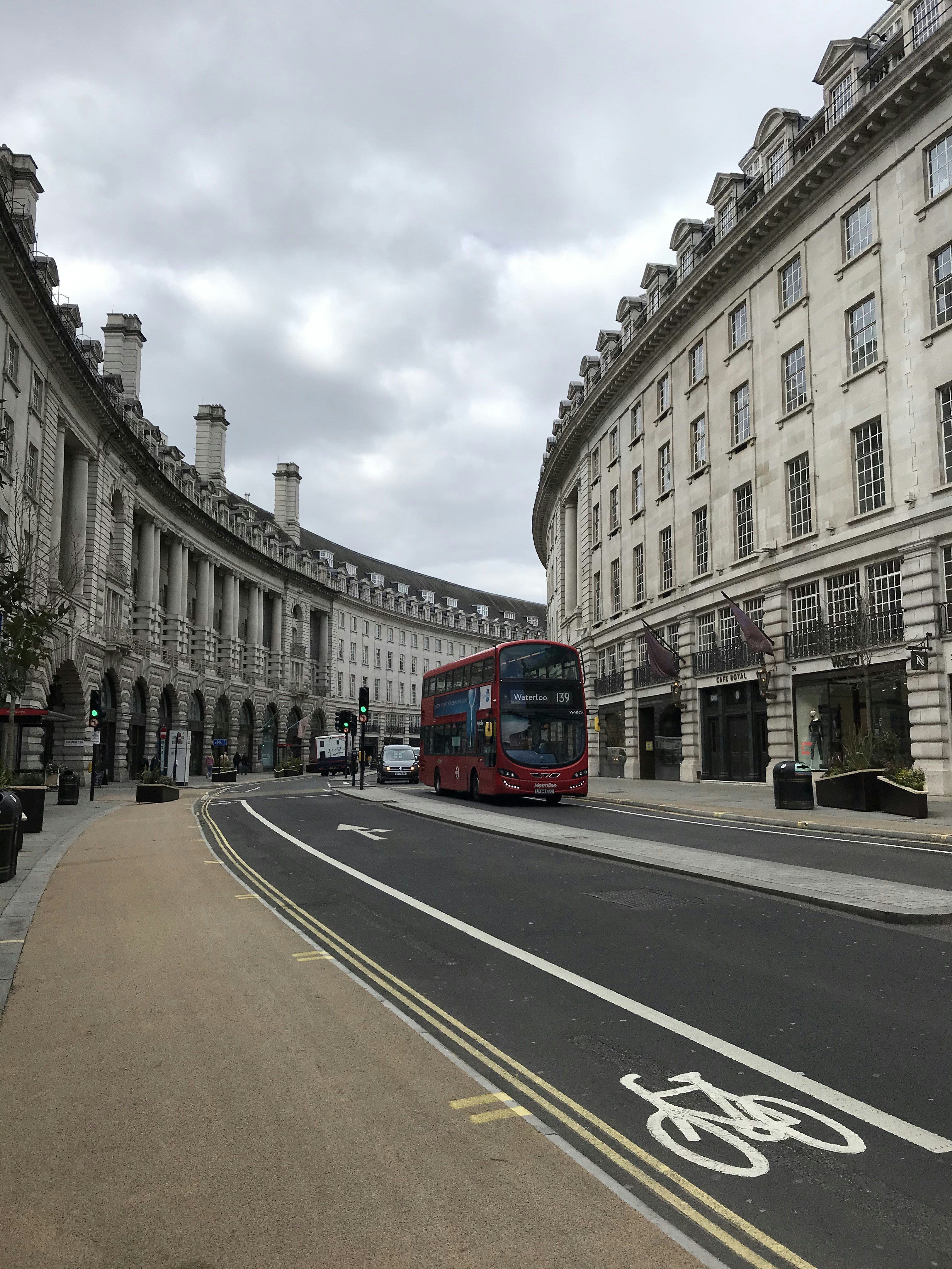 red bus on road near building during daytime