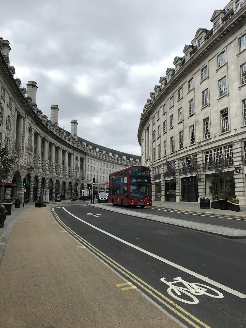 red bus on road near building during daytime