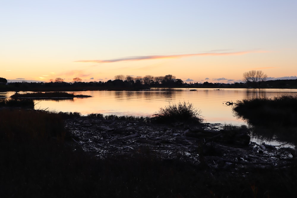 body of water during sunset