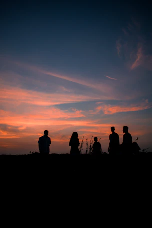A serene family silhouette standing together at sunset, symbolizing lasting legacy.