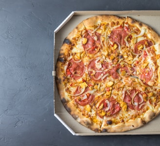 pizza on white cardboard box