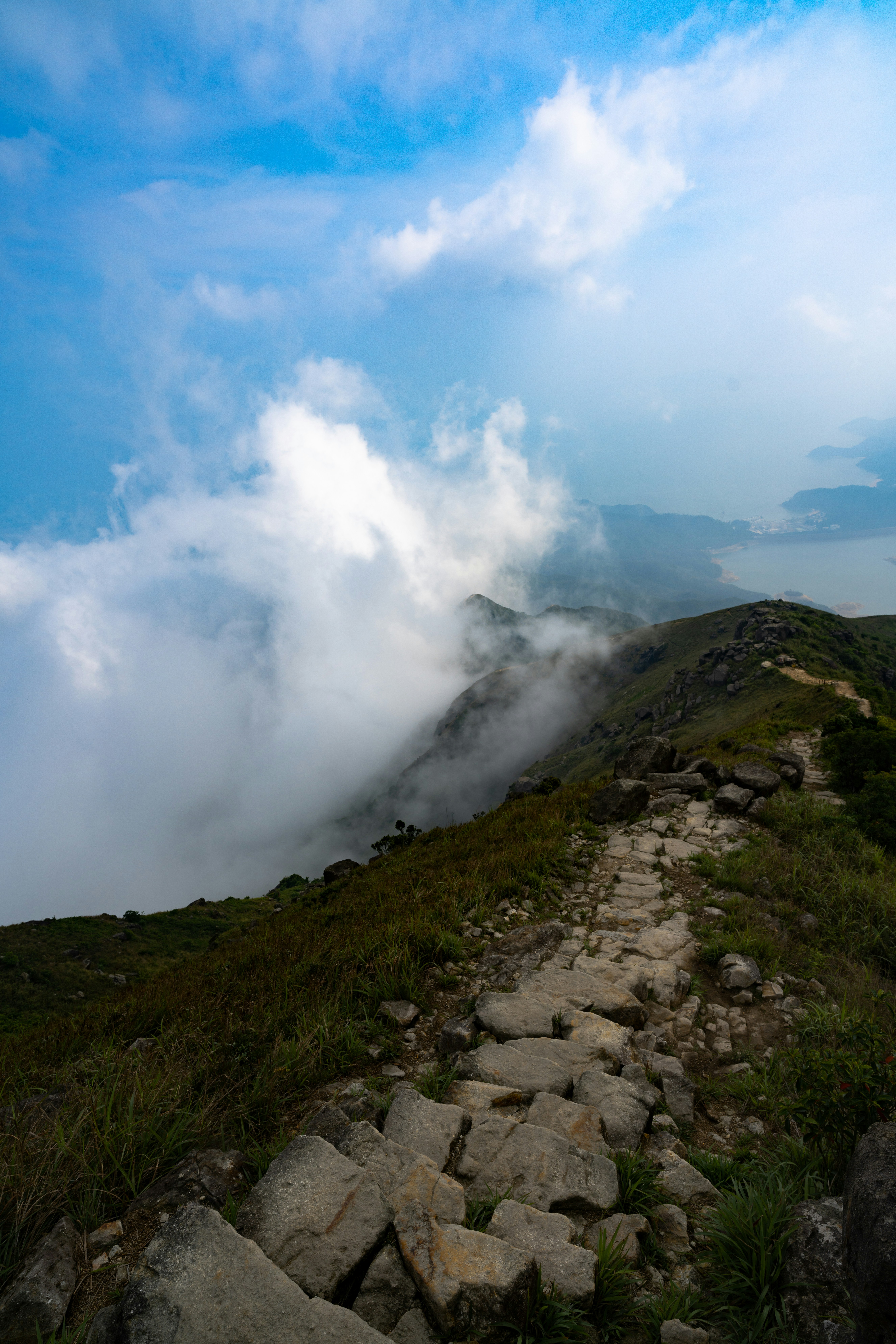green mountain under blue sky and white clouds during daytime
