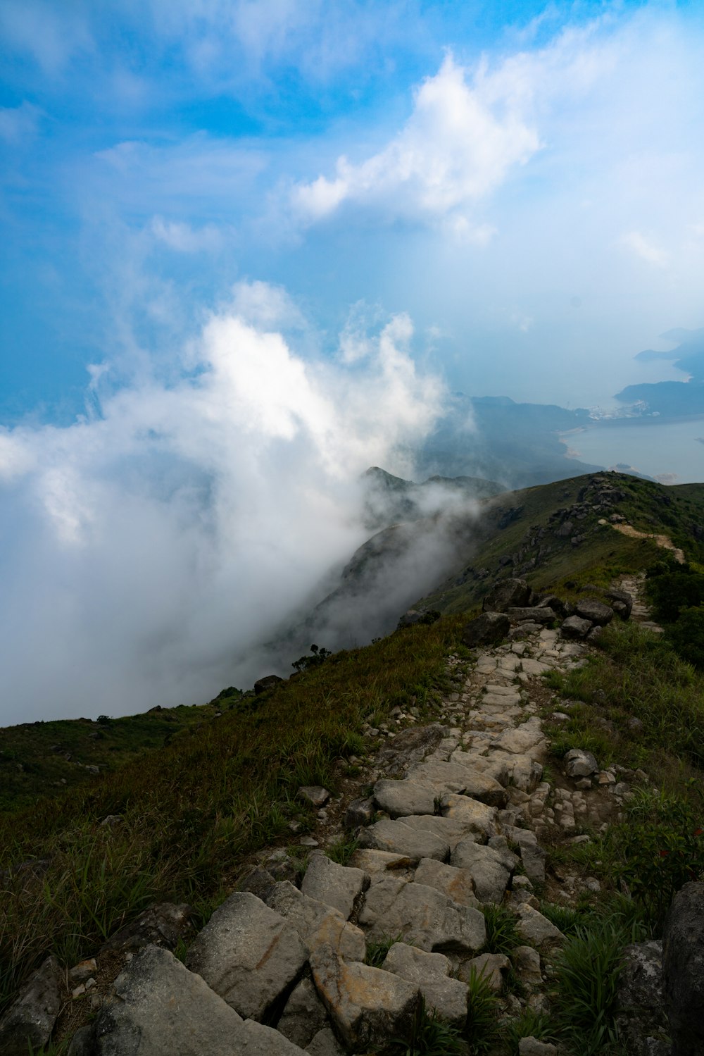 green mountain under blue sky and white clouds during daytime