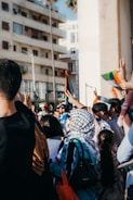people in black shirt holding flags during daytime