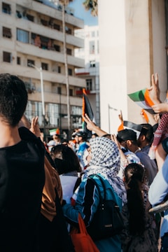 people in black shirt holding flags during daytime