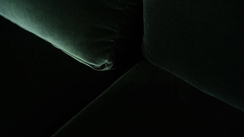 black throw pillow on black couch