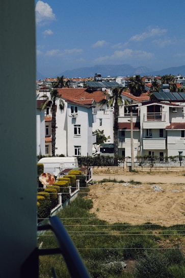 A friendly property manager discussing maintenance plans with community residents in a sunny Canary Islands neighborhood.