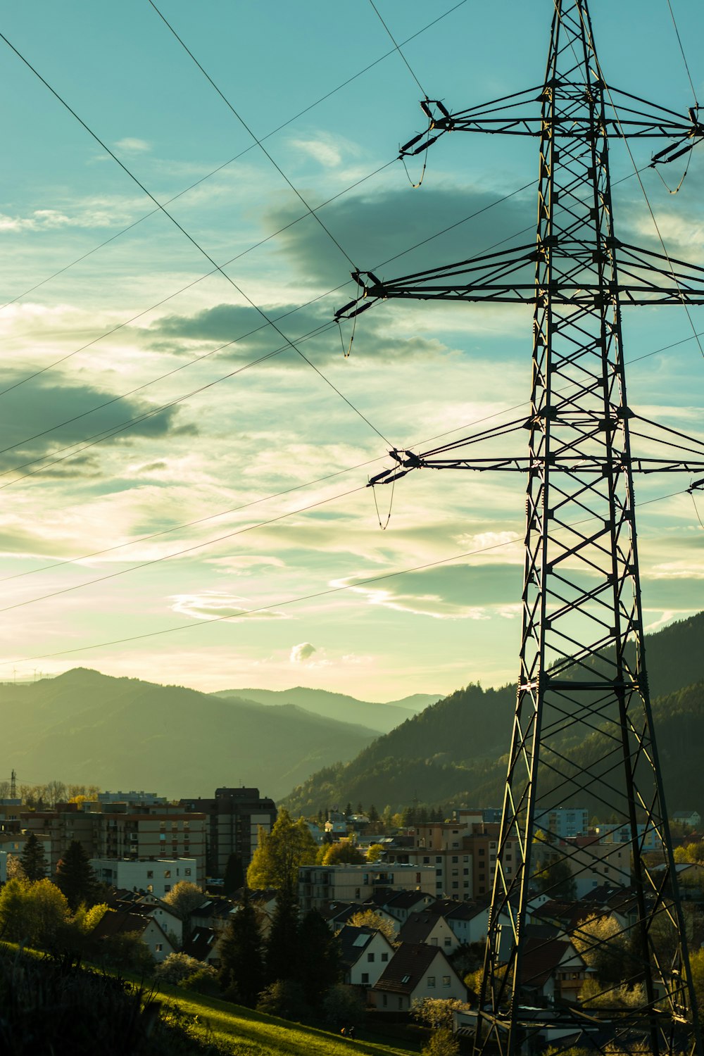 black electric tower near city buildings during daytime