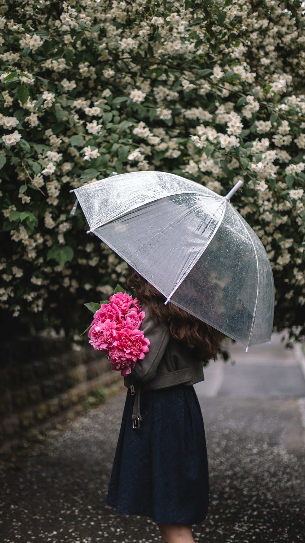 woman in black coat holding umbrella