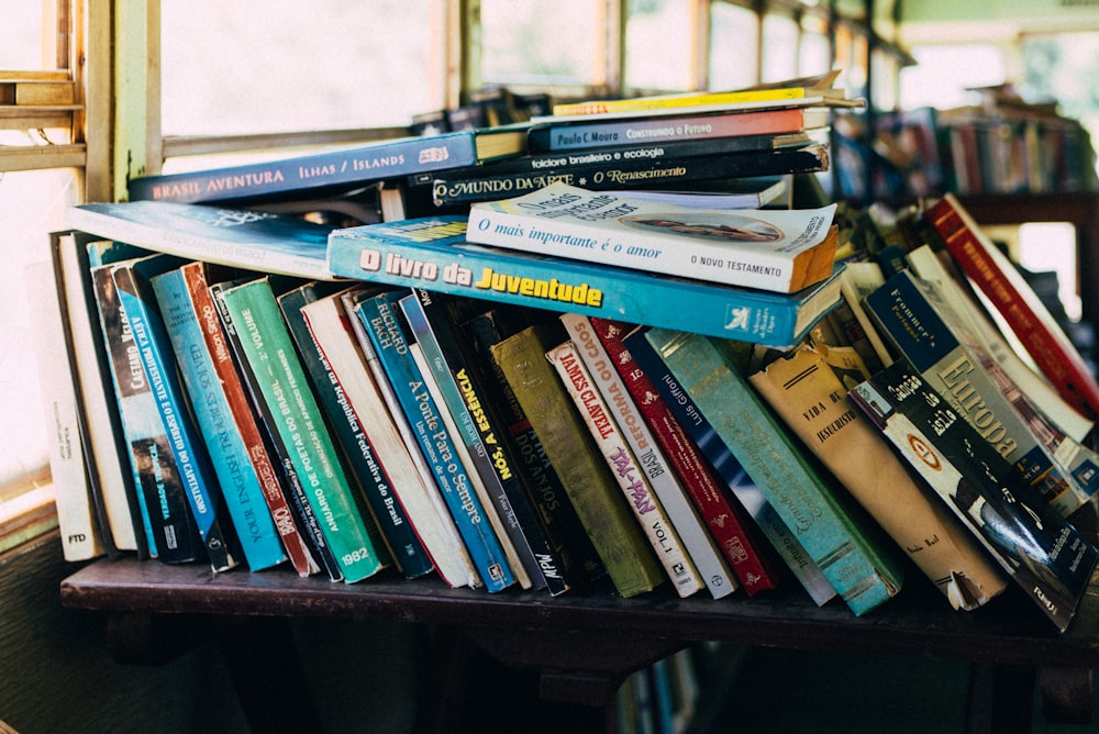 books on brown wooden shelf