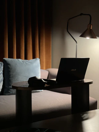 A cozy home setup with a billiards table and a laptop showing an online lesson.