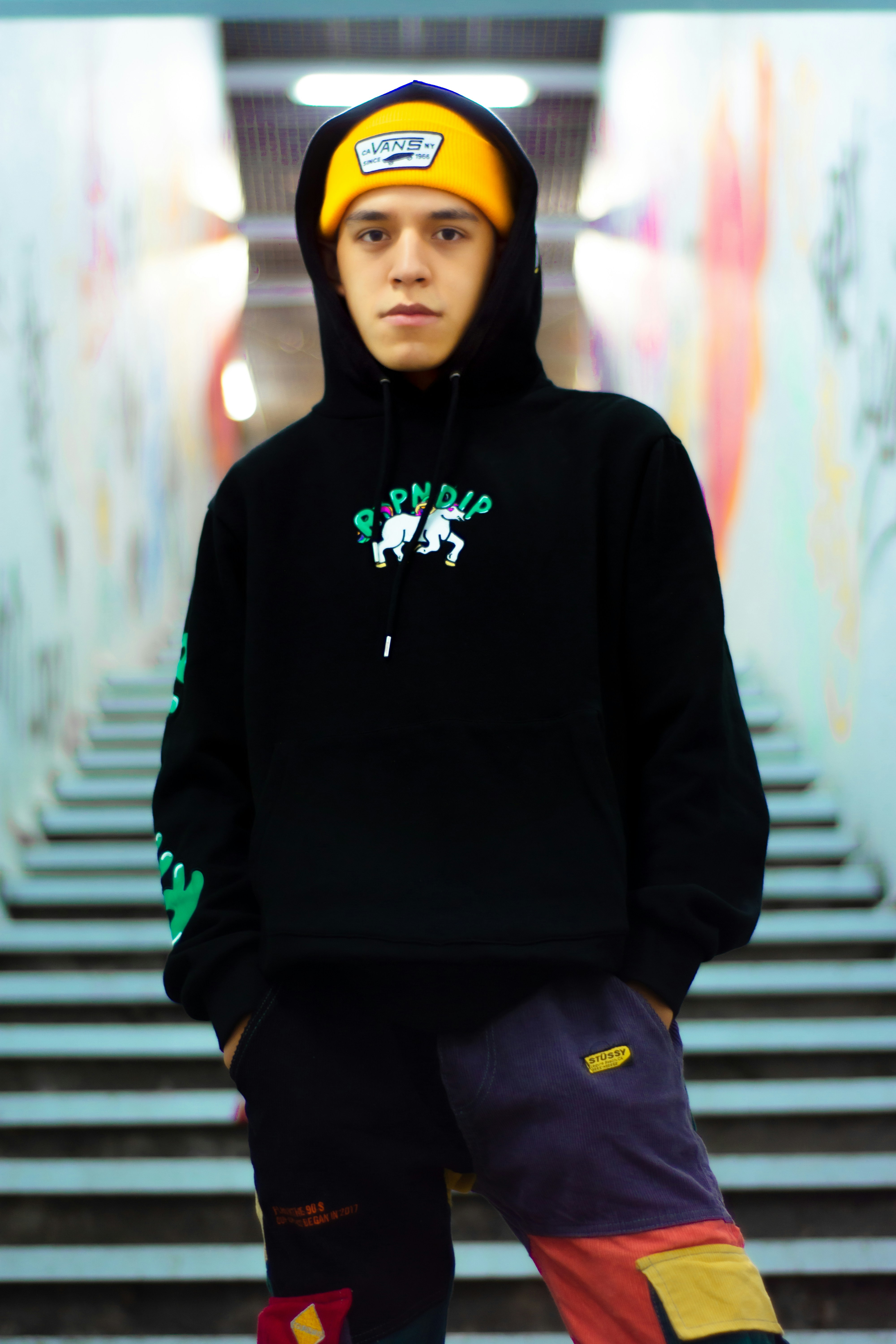 Young white man with beanie hat and casual jacket in urban street setting