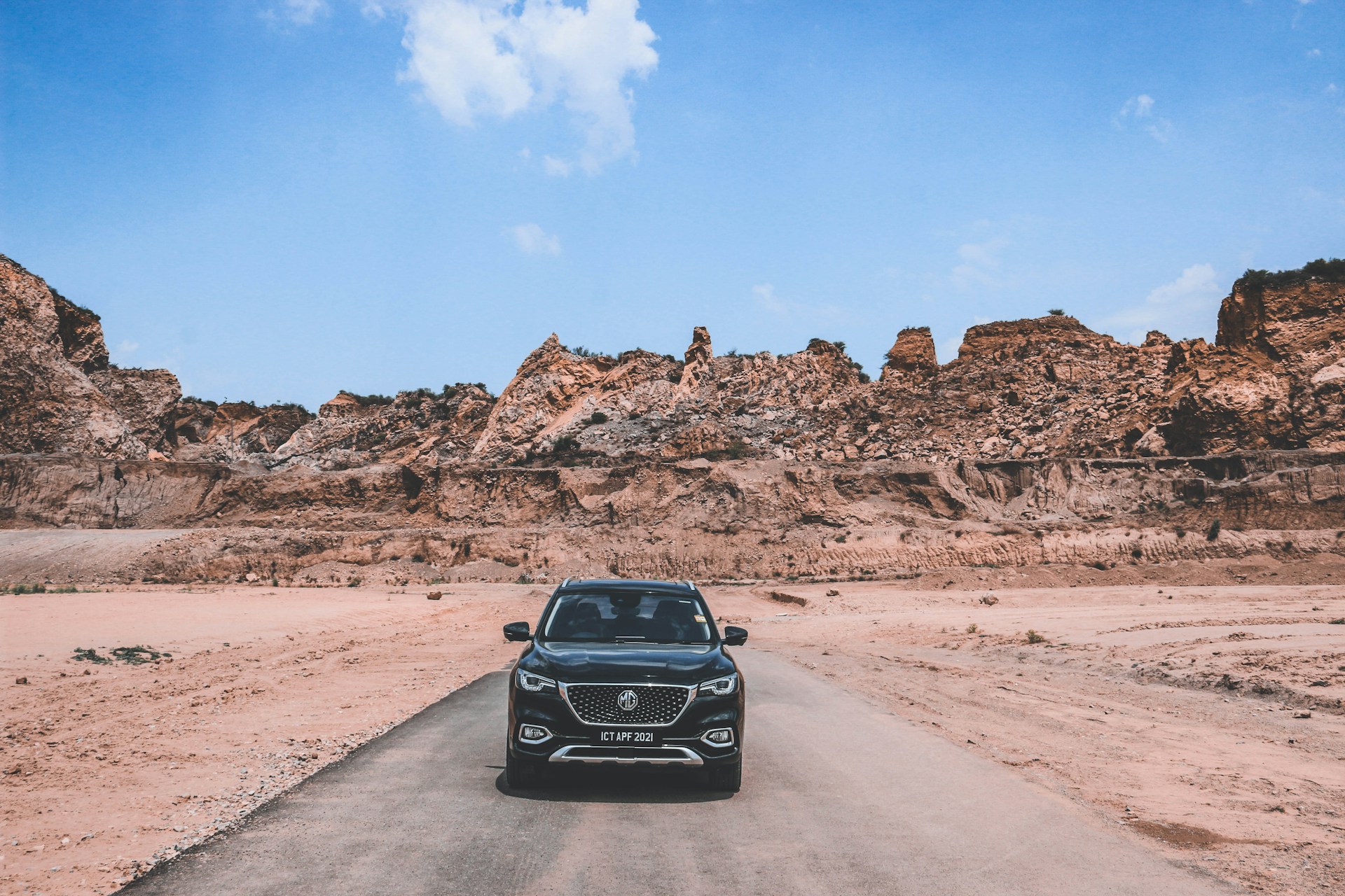 black car on brown dirt road during daytime