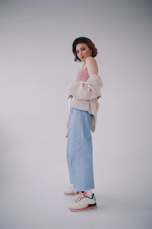 A vibrant photo of a young person wearing a pastel pink mini skirt and a white tank top, styled in a retro Windows 95 aesthetic.