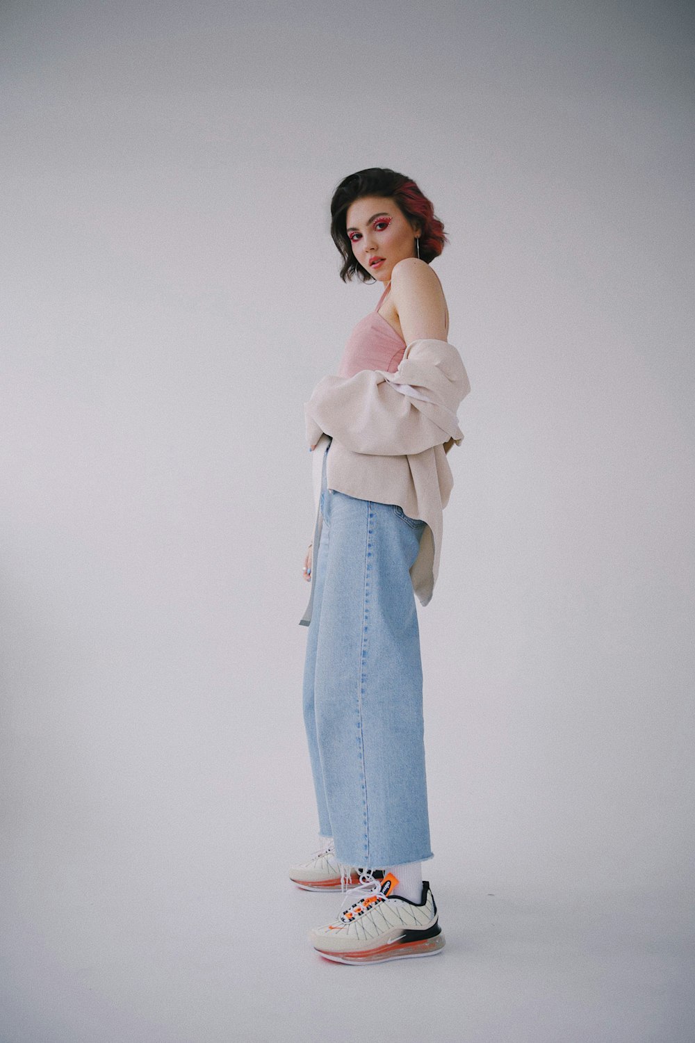 woman in white long sleeve shirt and blue denim jeans