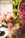 A close-up of a delicate peach and apricot floral bouquet with soft natural lighting.