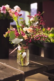 pink and white flowers in clear glass vase