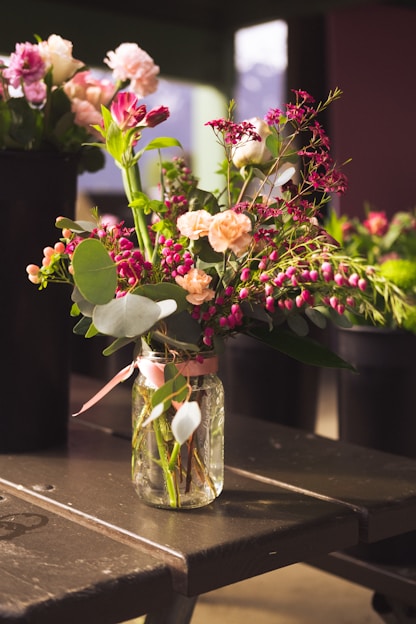 pink and white flowers in clear glass vase