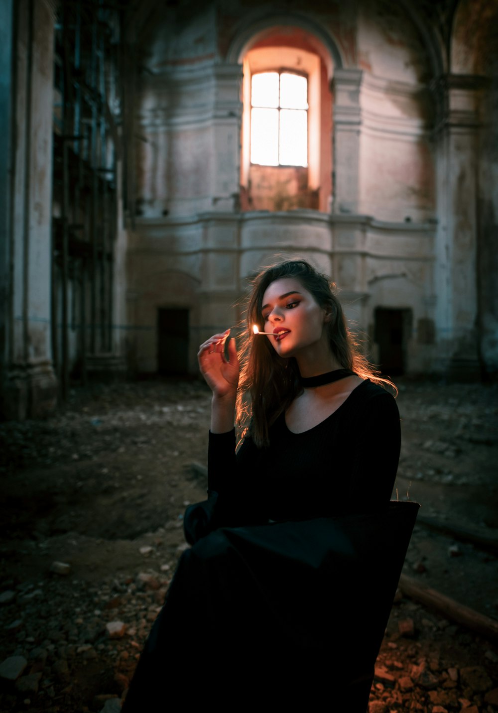 woman in black dress sitting on the ground