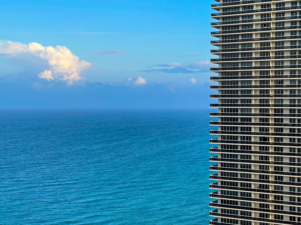 high rise building near sea under blue sky during daytime