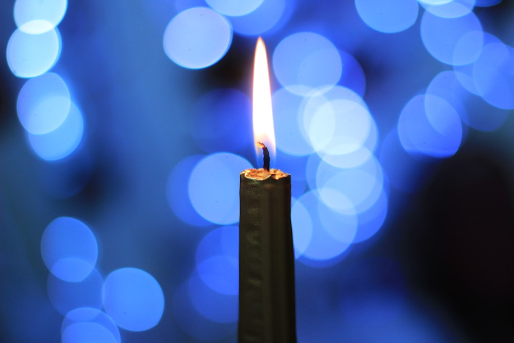 lighted candle in bokeh photography