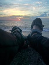 A serene beach scene with feet in the sand, reflecting wellness.