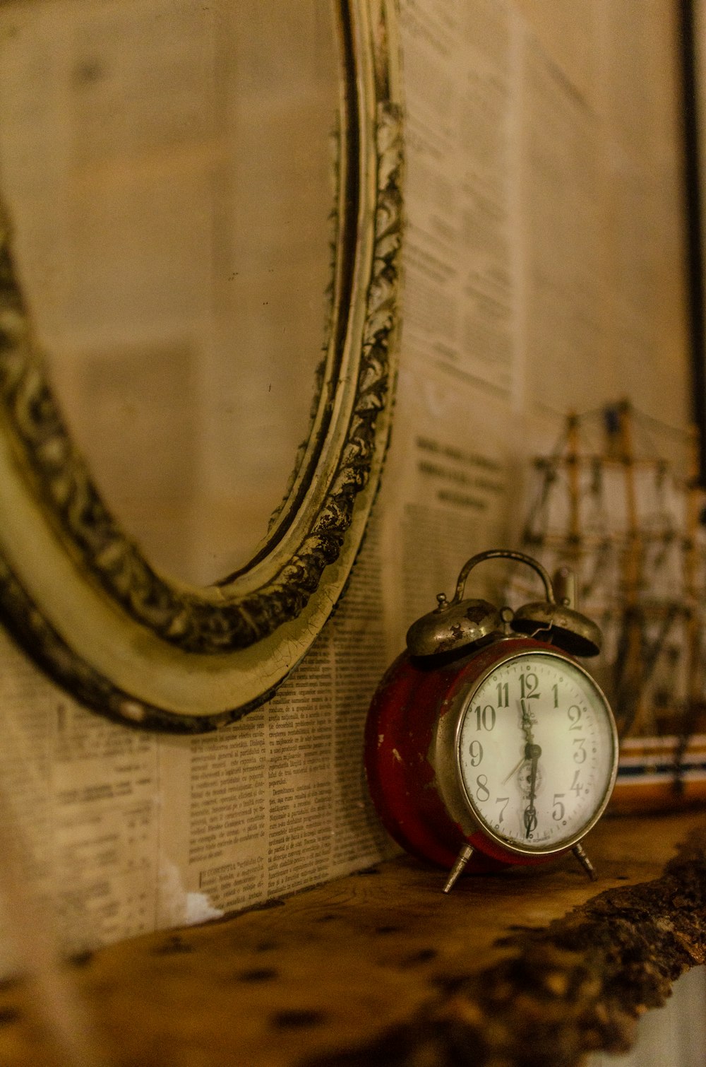 gold and red analog alarm clock