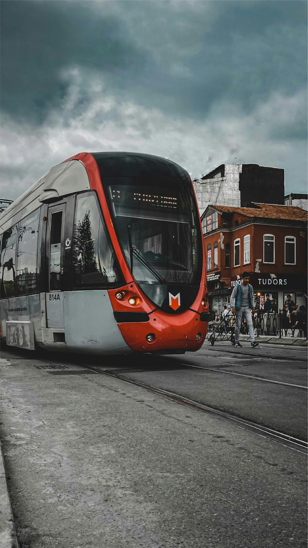 red and white tram on road during daytime